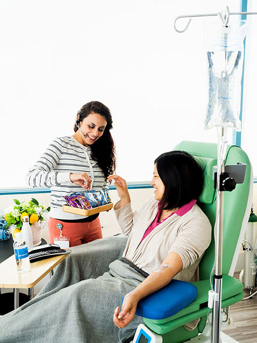 Staff offering snacks to patient