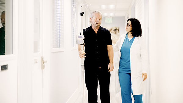 Infusion nurse walking with patient