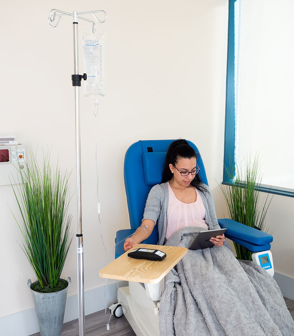 A woman is receiving infusible care at an IV center