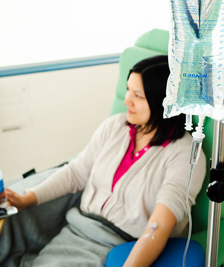 A lady is receiving infusible care therapy at an IV center