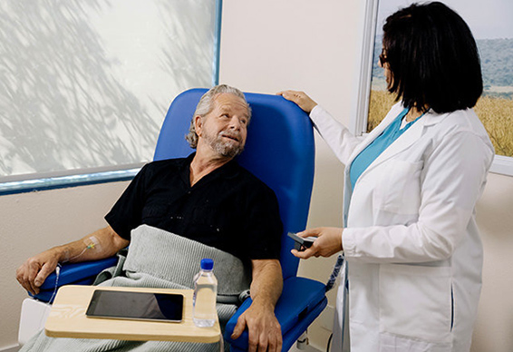 Patient receiving an infusion consults with a nurse at IV infusion center.