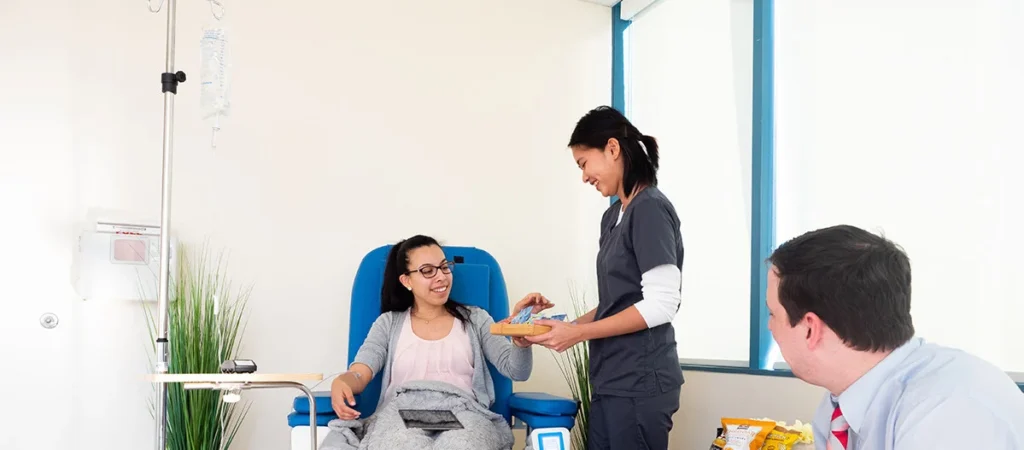 Nurse offering snack to infusion therapy patient