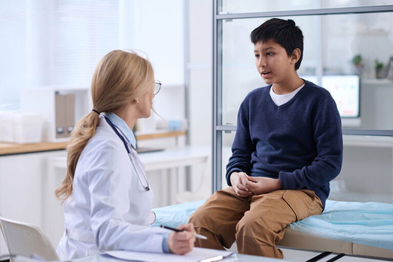 Doctor consulting with boy about Fabry disease.