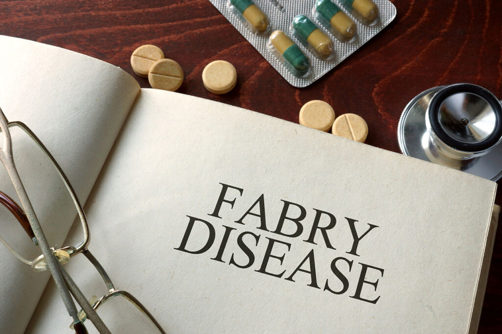 Doctor's desk with book opened up to a section on Fabry disease.