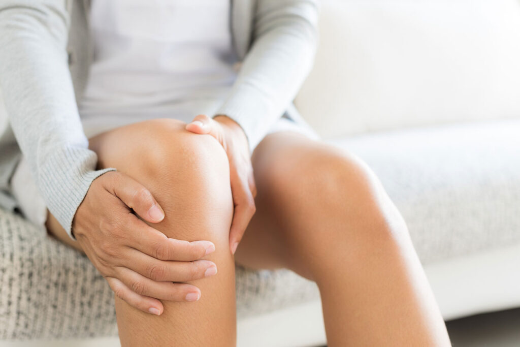 Woman experiencing joint pain from Gaucher disease.