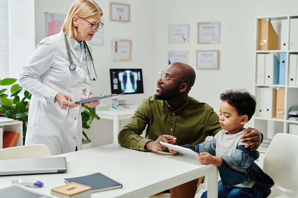 Doctor consulting with parent and child about MPS