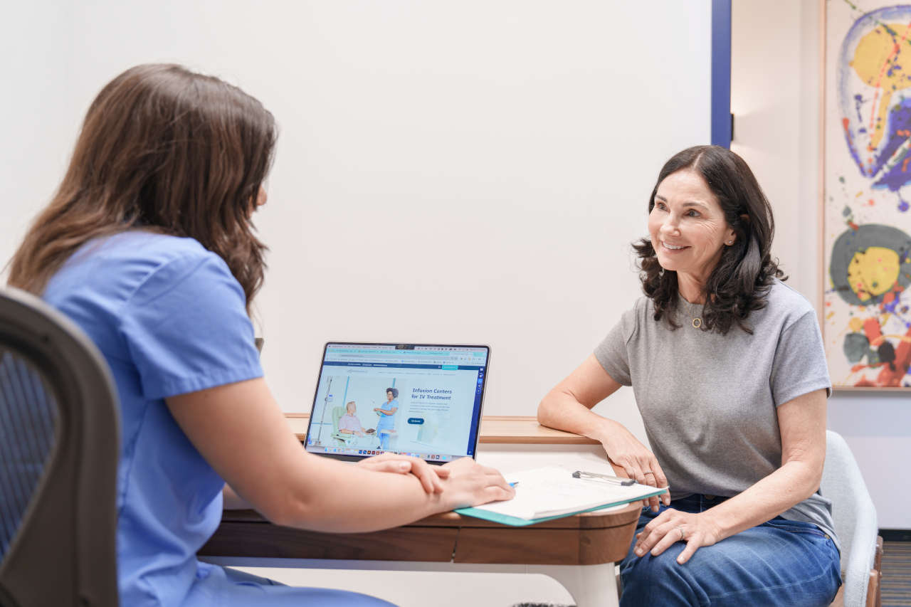 Nurse talking to patient at AmeriPharma Infusion Center