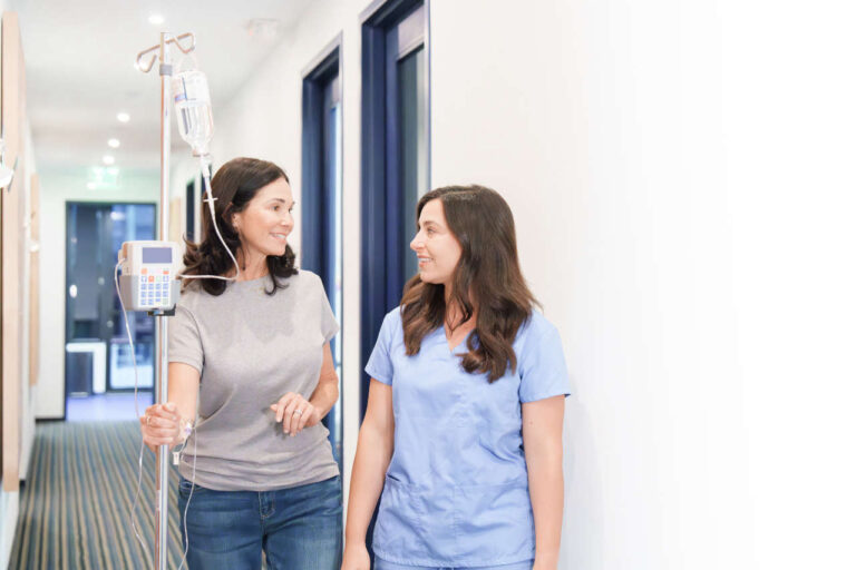 Nujrse and patient walking around in infusion center