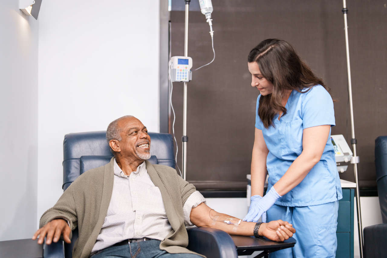 Nurse checking on patient receiving an infusion
