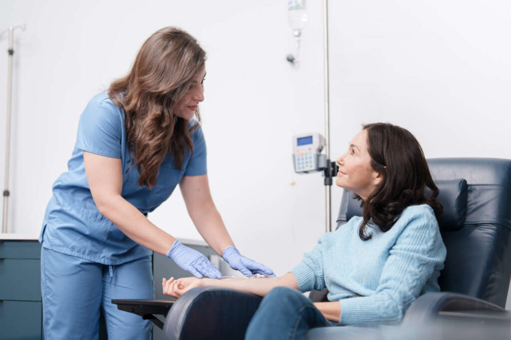Nurse interacting with infusion patient