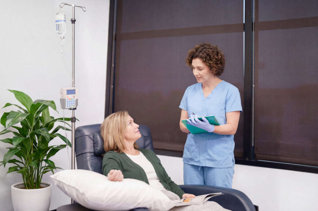 Nurse tending to patient in the Stuart infusion center