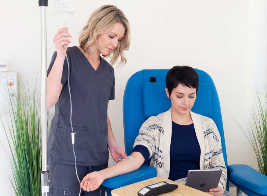 Nurse setting up infusion therapy for a patient