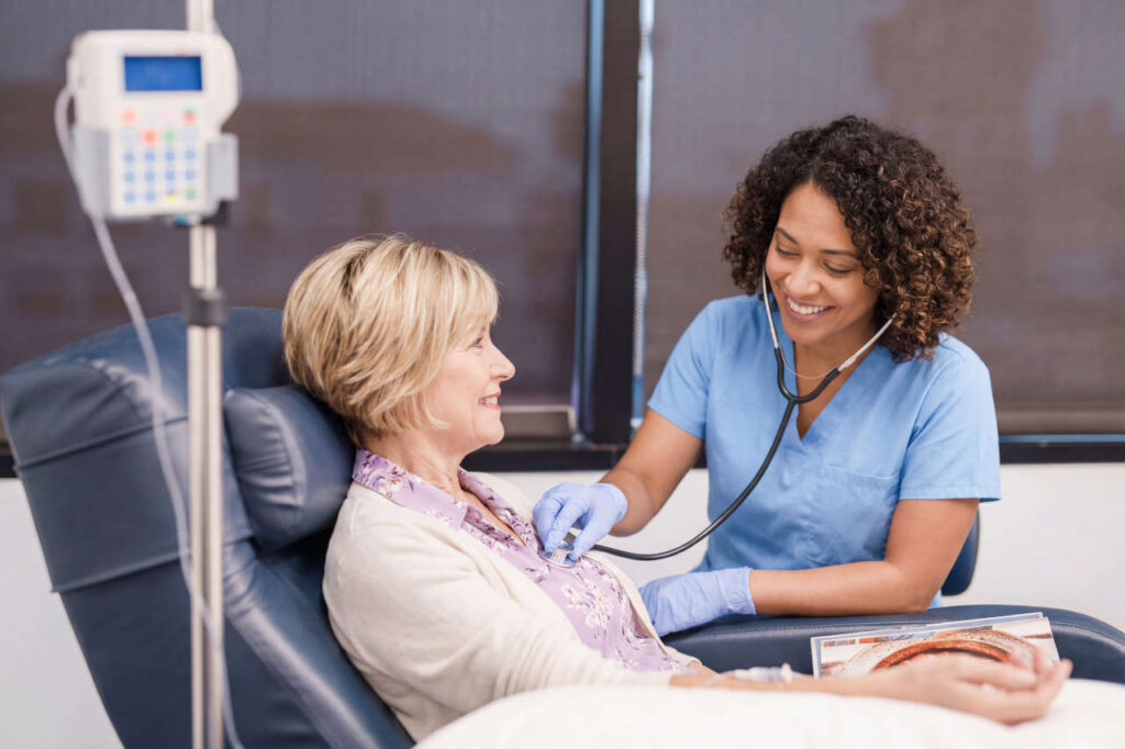 Nurse with patient in an infusion suite at Trinity infusion center