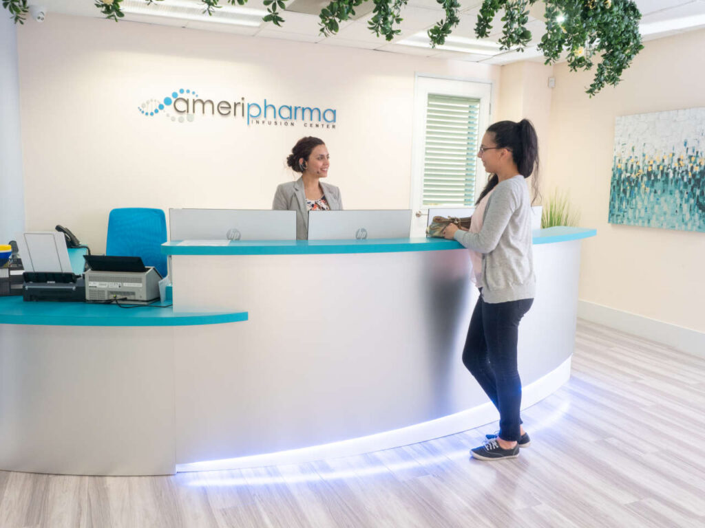 Patient being greeted at front desk of Orange Infusion Center