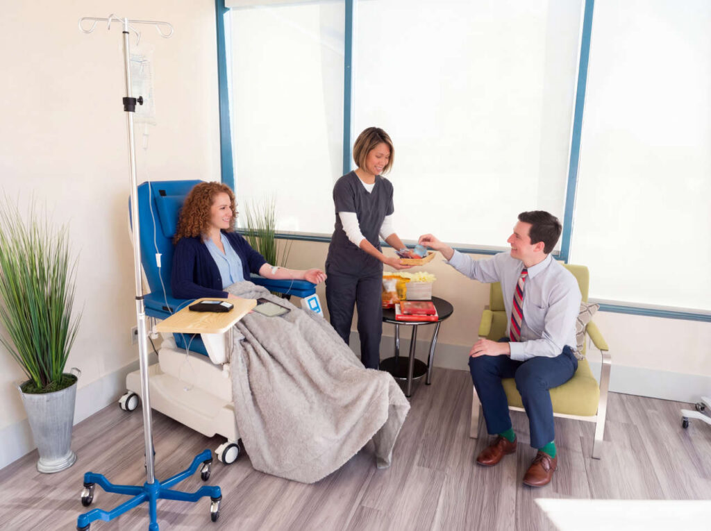 Nurse offering snacks to patient and guest at Stuart Infusion Center