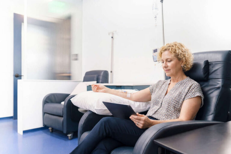 Woman sitting in comfortable chair at an infusion center, receiving Gammagard
