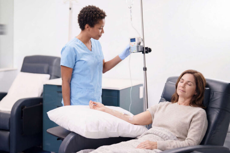 Patient in reclining chair receiving IVIG therapy at an infusion center